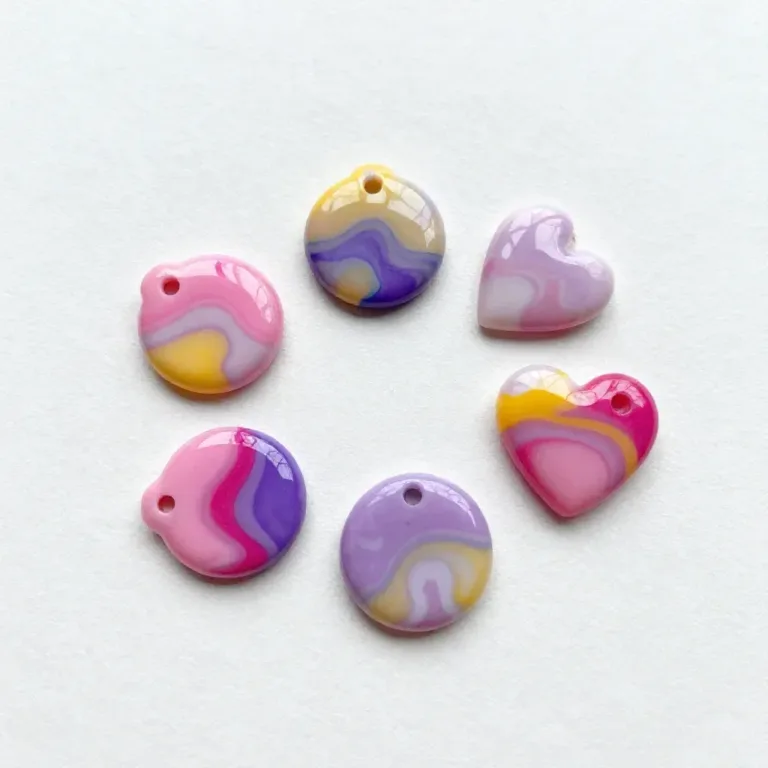 Colorful marbling crafts created with nail polish on paper and fabric.