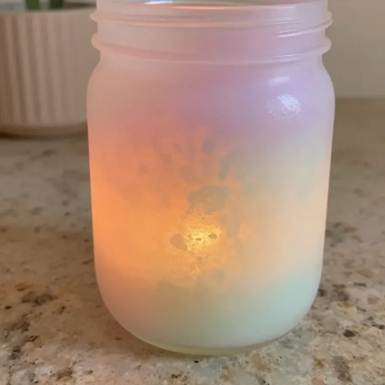 Pastel wedding candle holder adding coziness to a beautiful wedding setup.